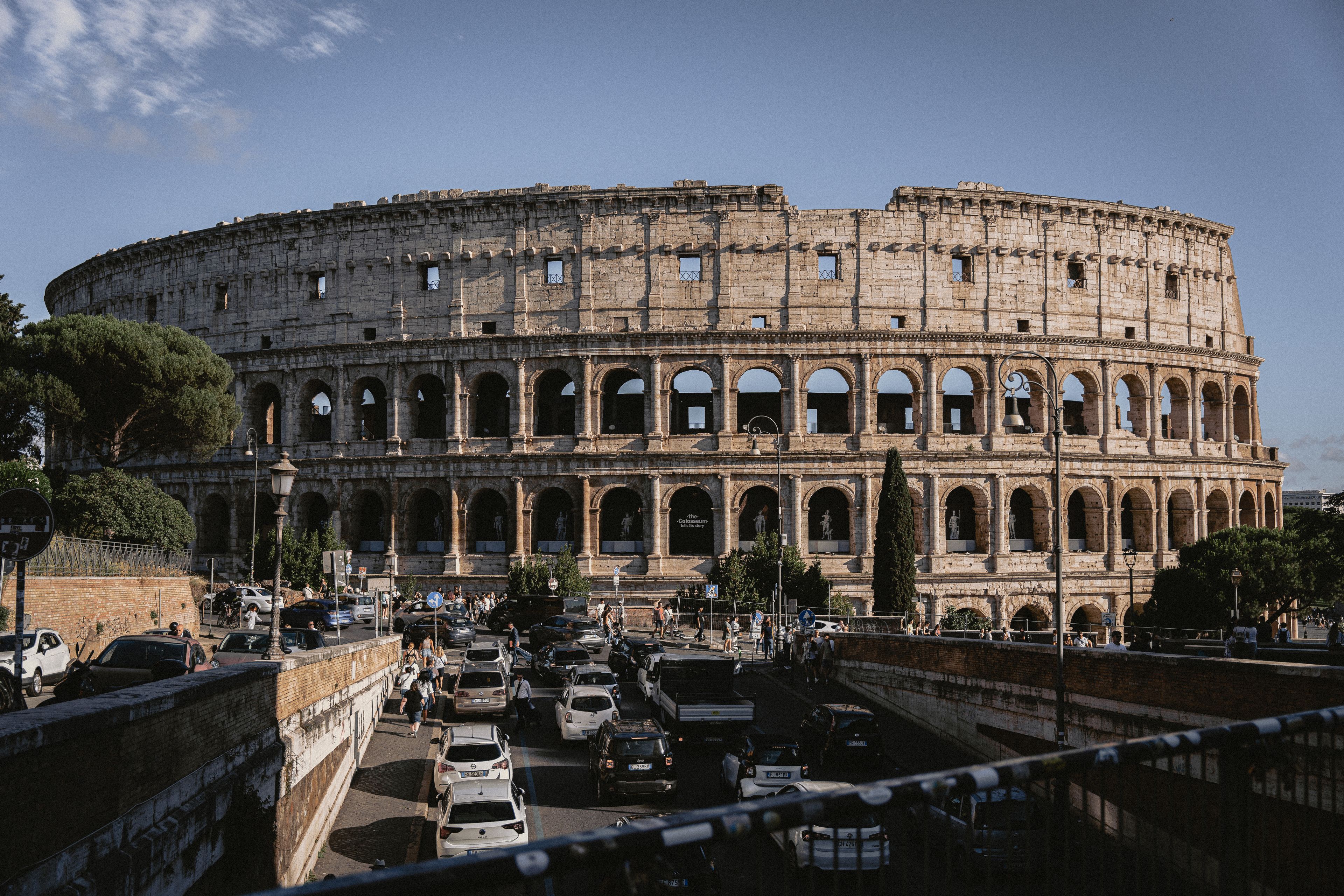 The Colosseum stands majestically amidst bustling Rome, an iconic remnant of ancient architecture.