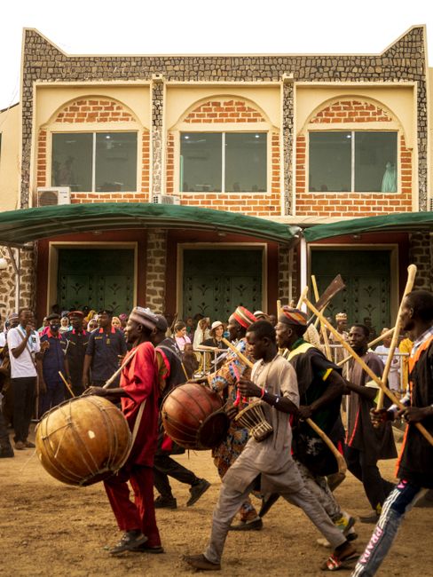 Vibrant traditional parade with drummers in Nigeria showcasing rich cultural heritage.