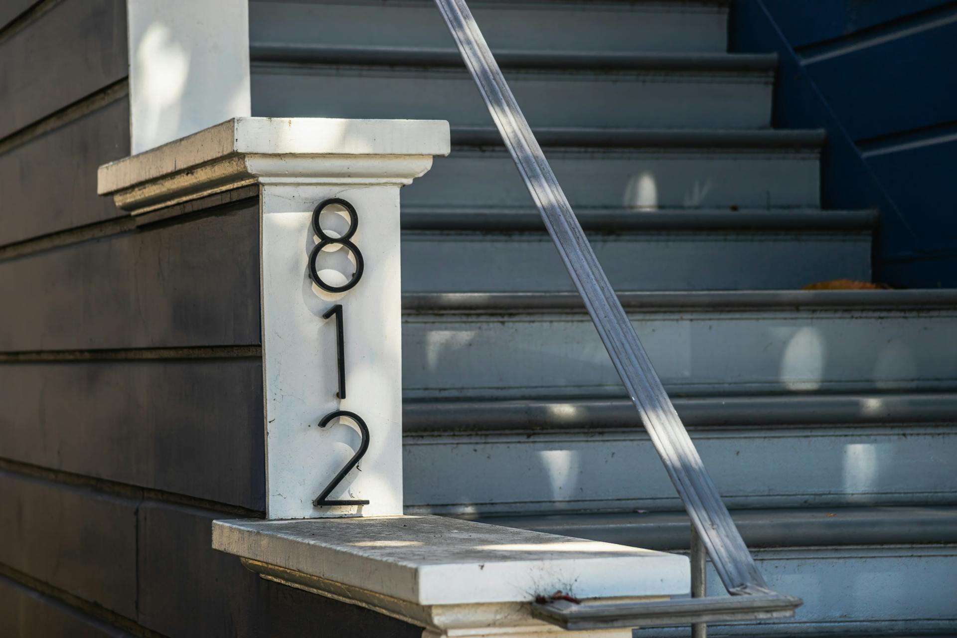 A number sign on the steps of a house