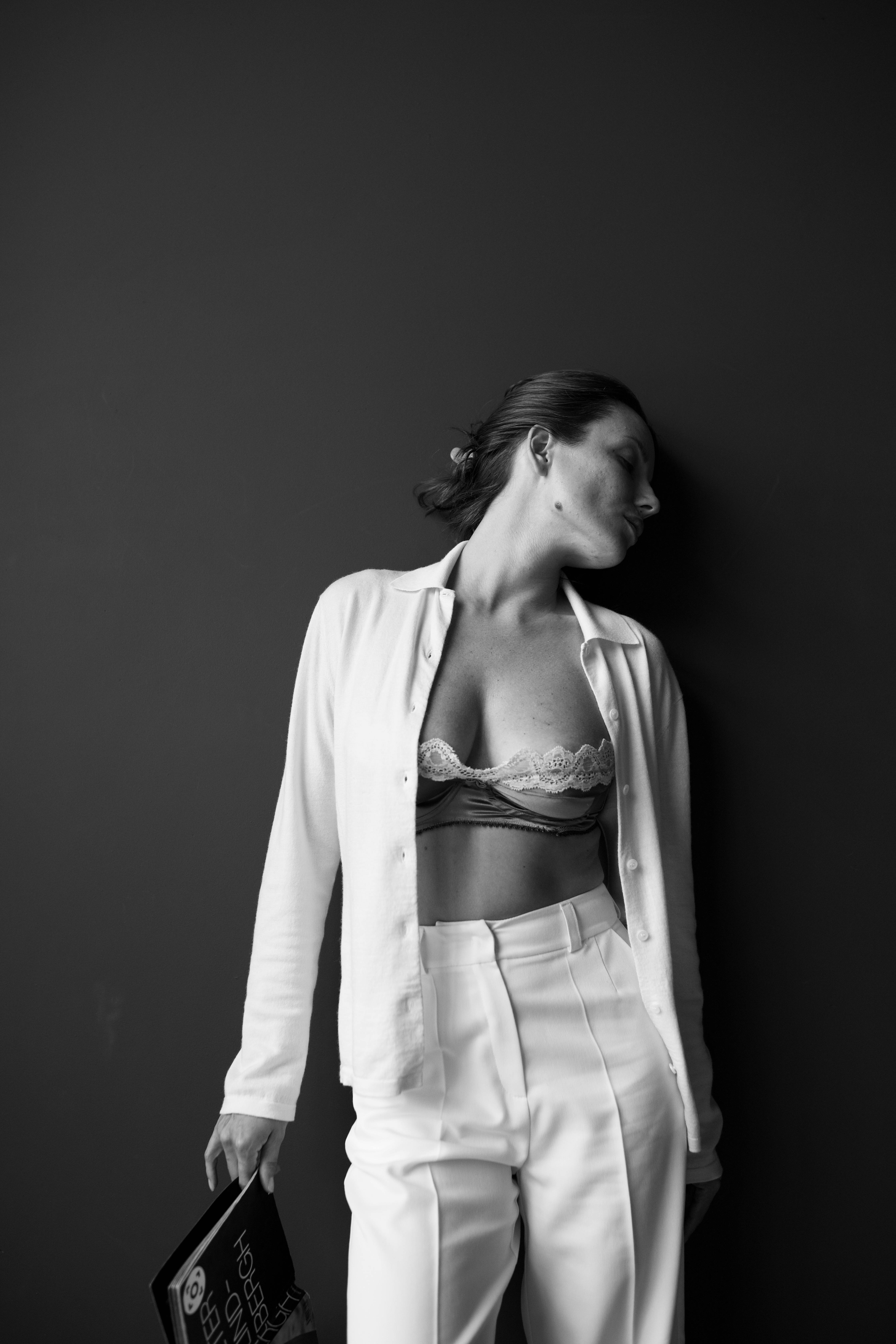 A woman in white pants and a white shirt