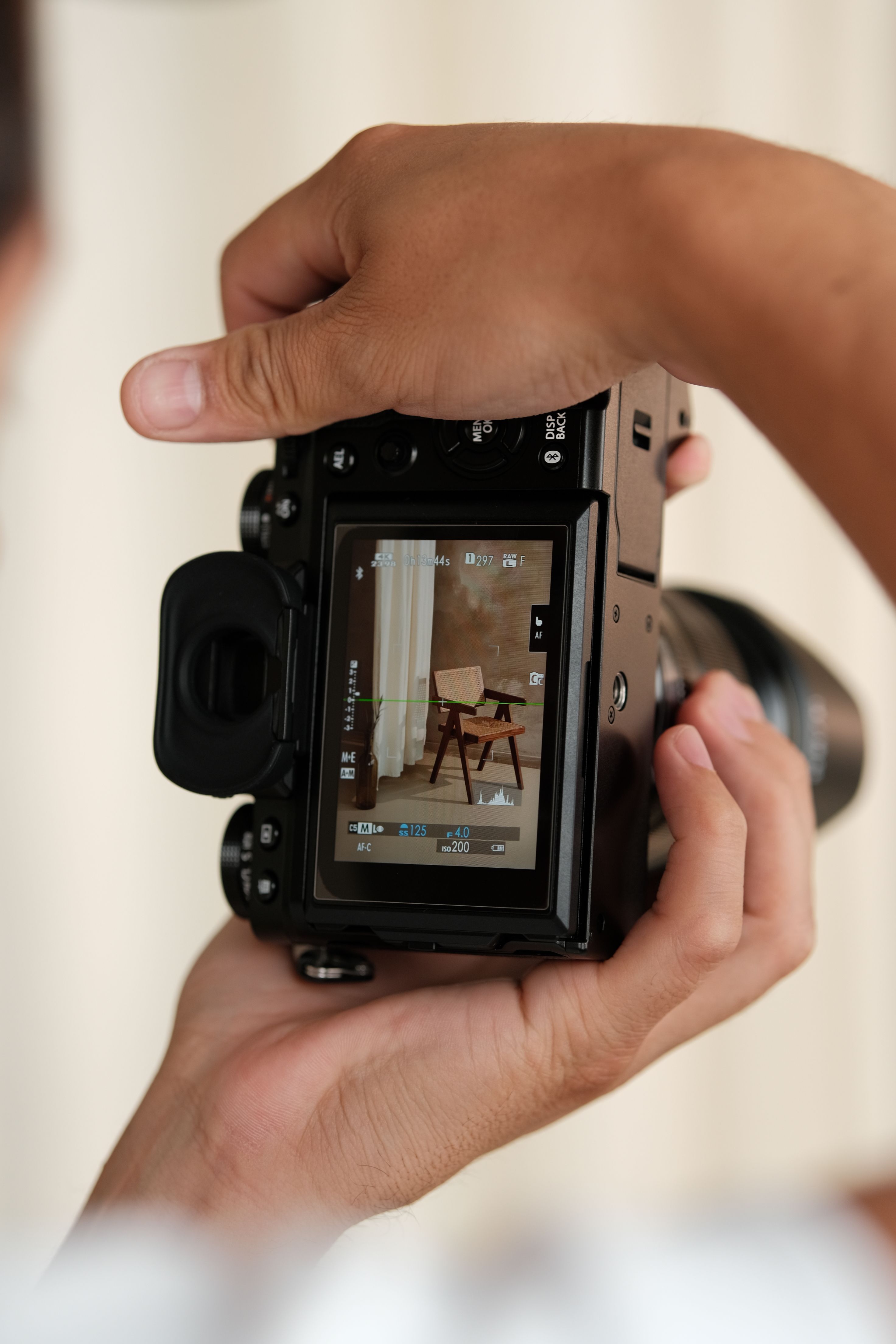 A digital camera capturing an elegant armchair in an indoor setting.