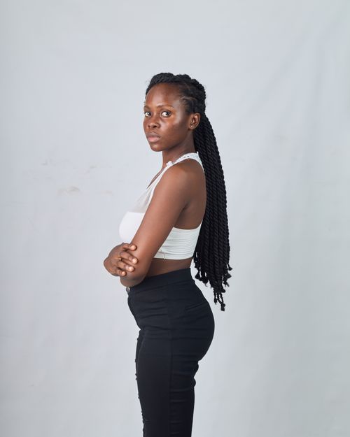 Free Portrait of a young woman posing confidently in fashionable clothing against a neutral background. Stock Photo
