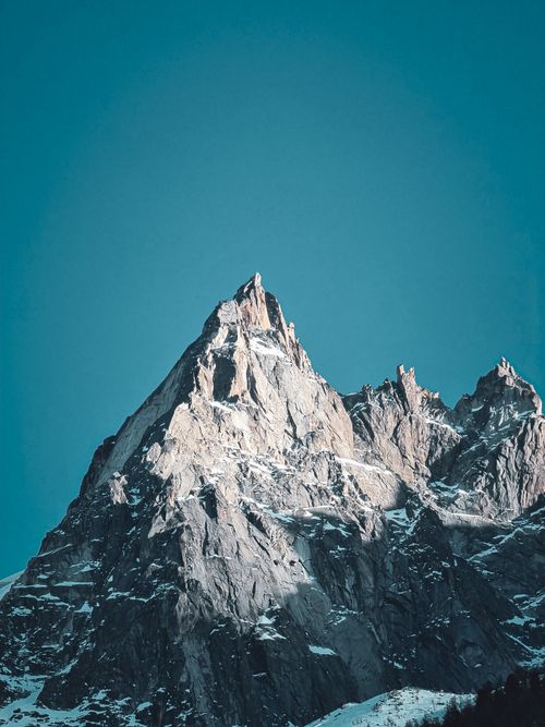 Free A stunning view of a snow-capped mountain peak in Chamonix, France under a clear blue sky. Stock Photo