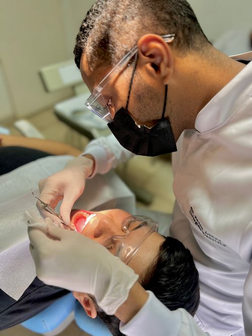 Free Dentist examining a patient's teeth in a clinic setting with professional care. Stock Photo