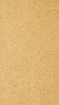A seamless textured yellow surface ideal for backgrounds in design projects.