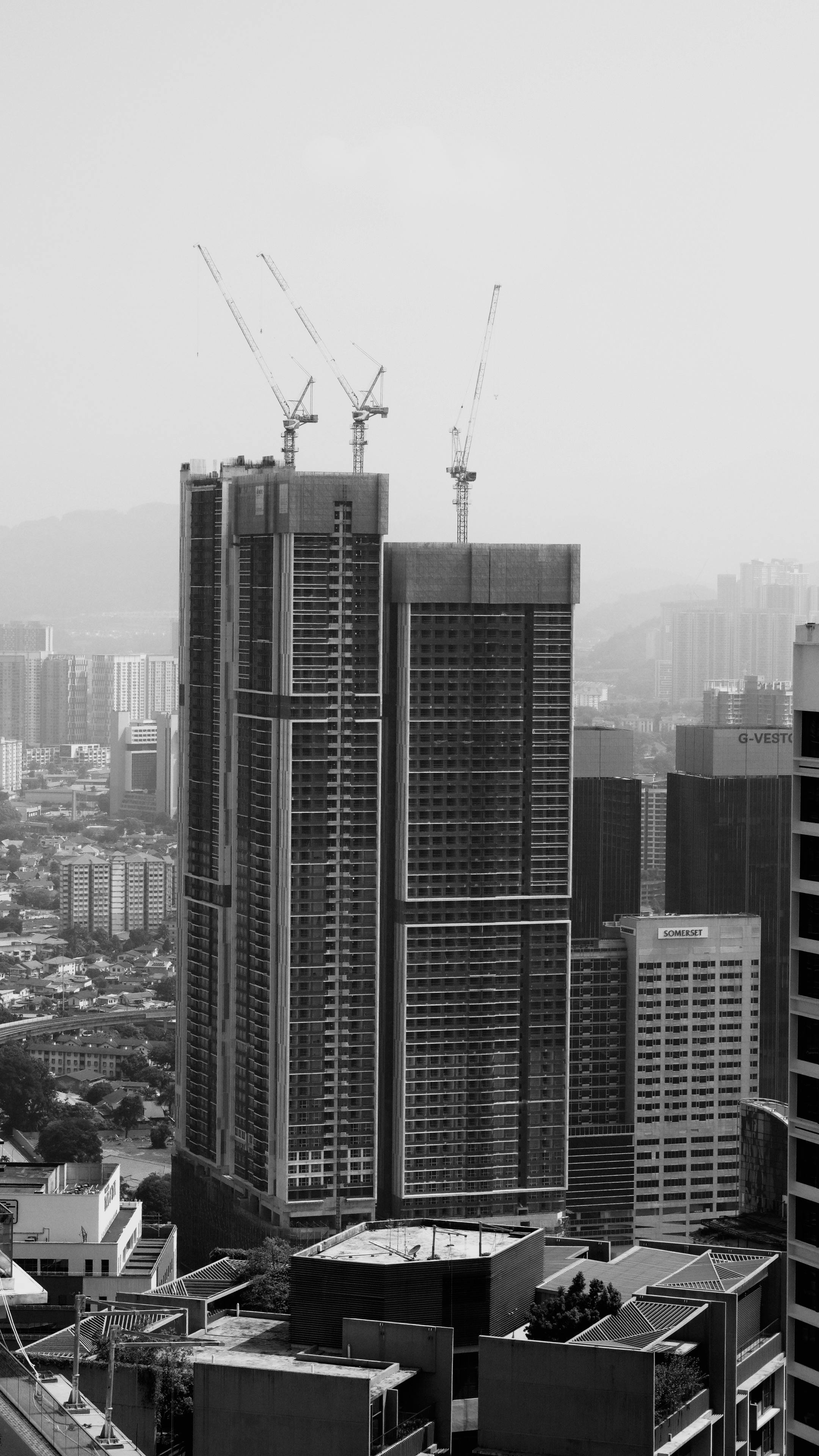 Black and white photo of city skyscrapers under construction, showcasing urban architecture.