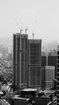 Black and white photo of city skyscrapers under construction, showcasing urban architecture.