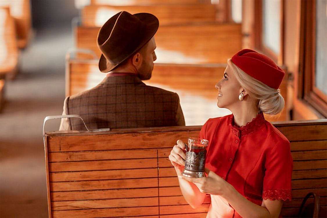 Man And Woman Sitting Opposite Each Other