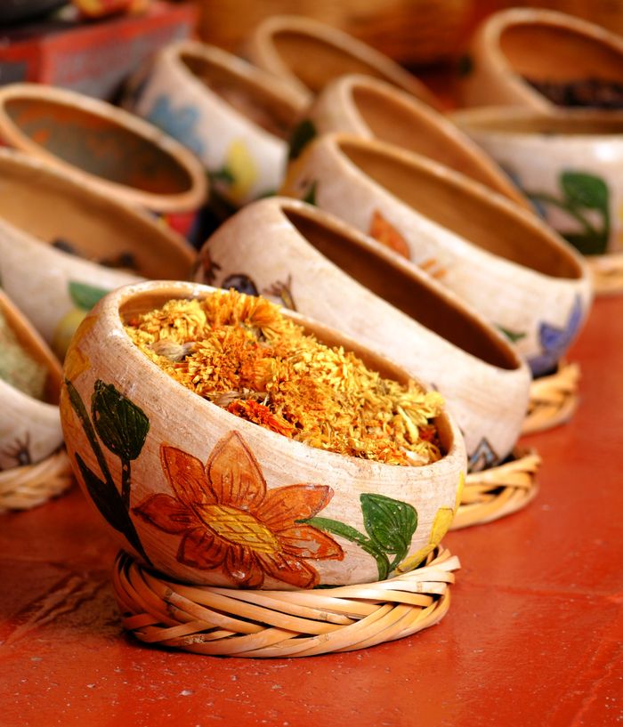 Hand-painted clay bowls filled with dried flowers and spices. Photo by Ricardo Olvera on Pexels