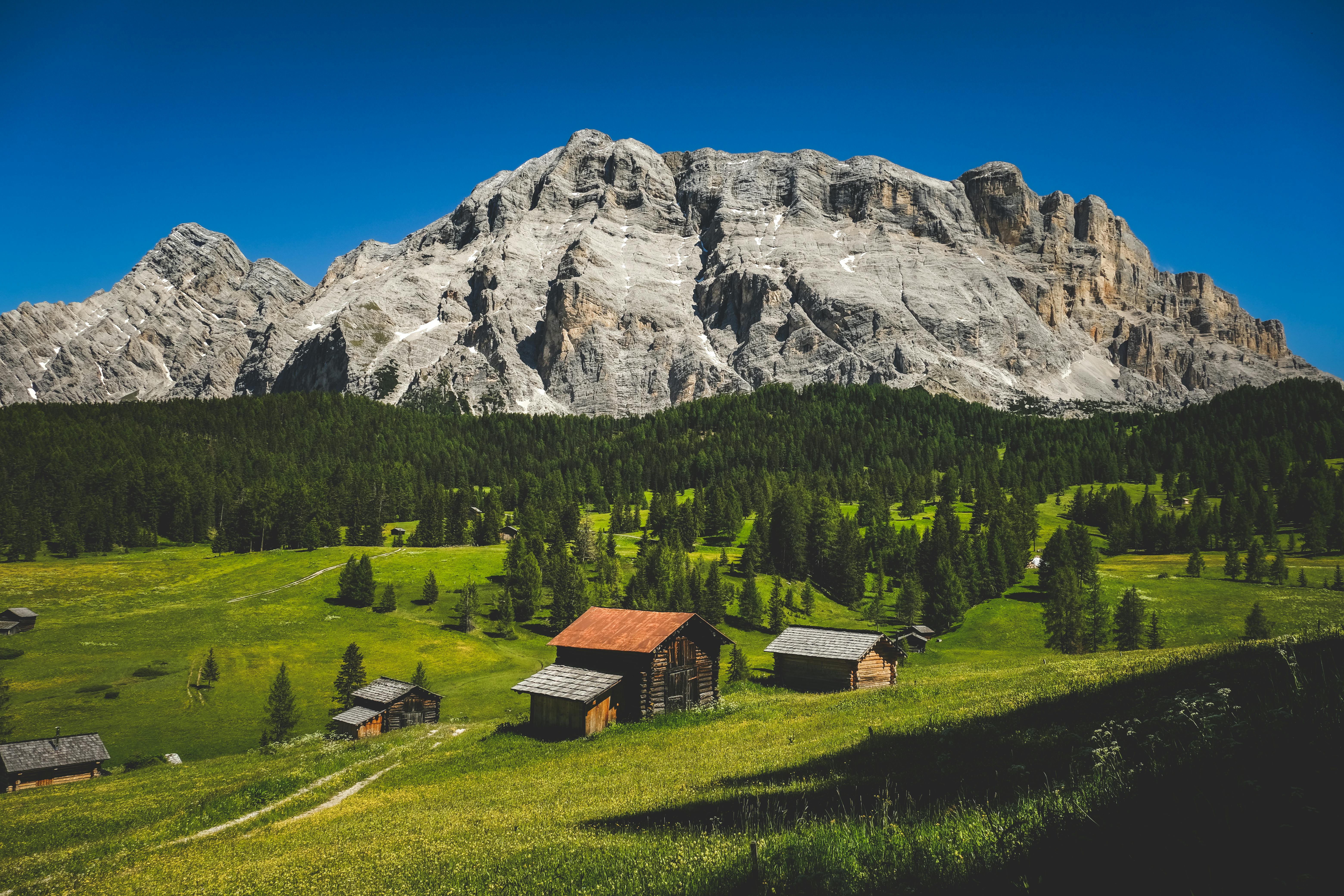 a mountain range with a small cabin in the middle