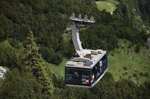 Free Explore picturesque mountain views with a cable car ride through stunning greenery. Stock Photo