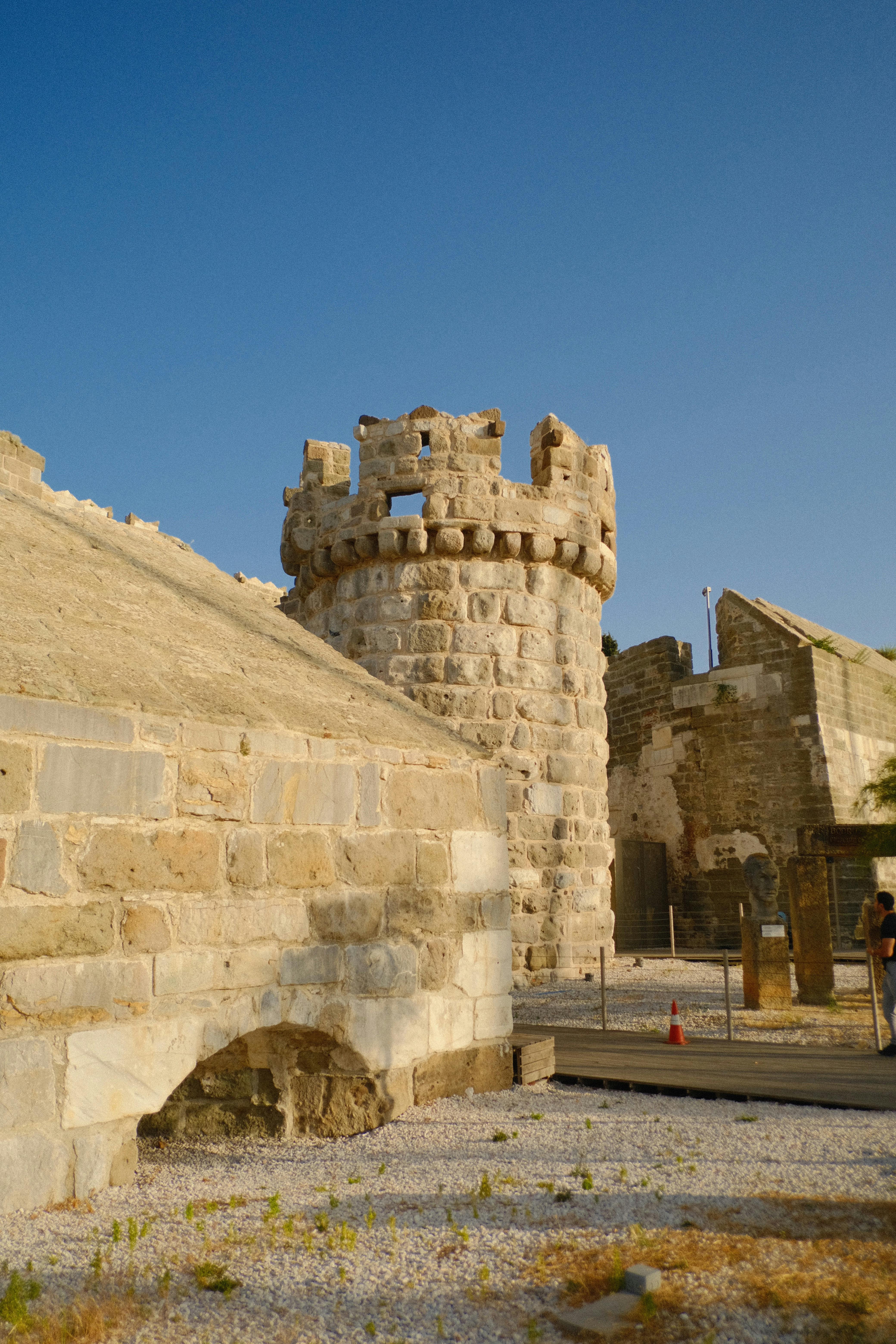 The old stone castle is surrounded by a stone wall