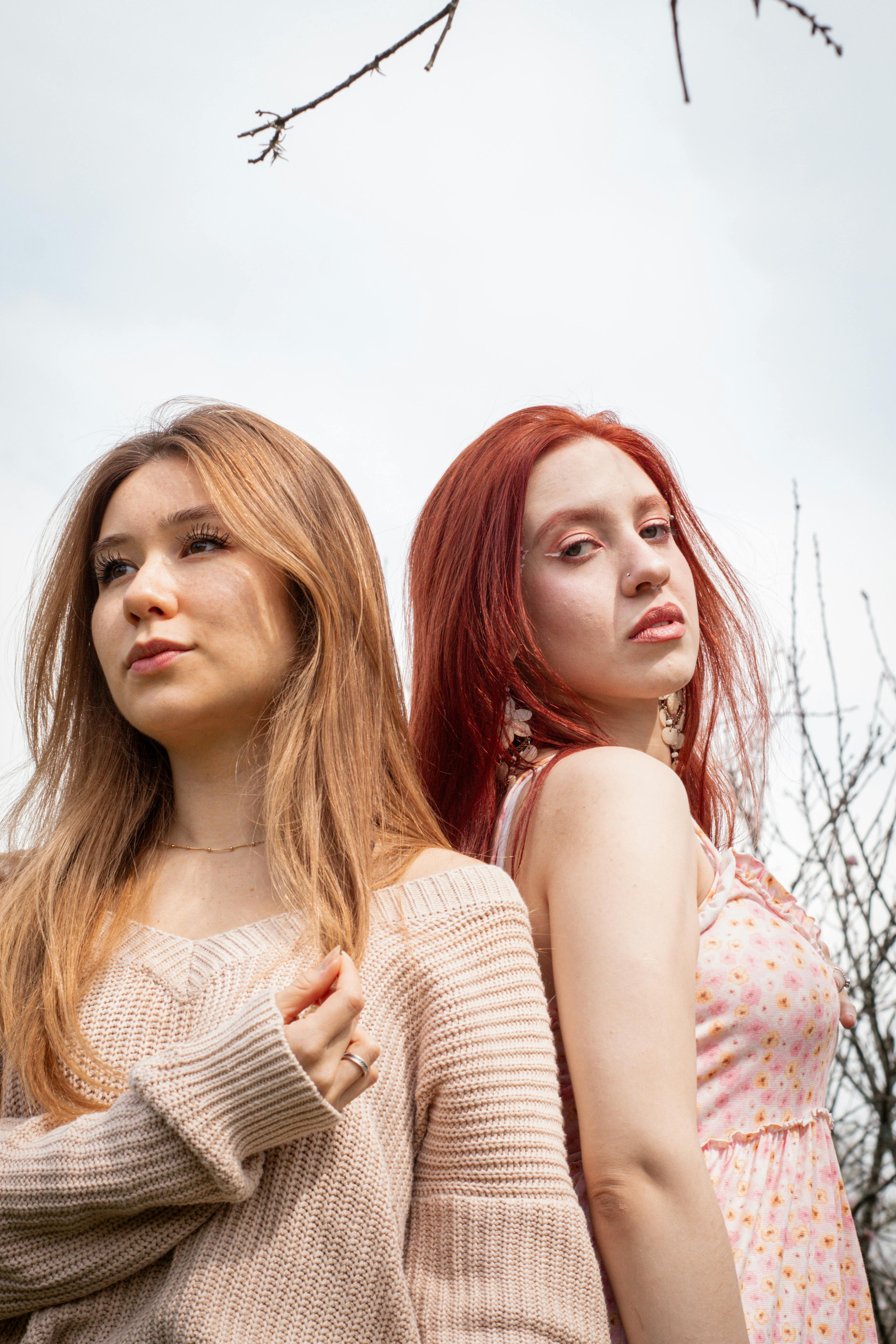 two young women with red hair standing next to each other