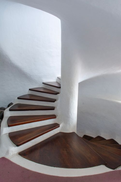 Free Contemporary spiral staircase with wooden steps in a minimalist interior. Stock Photo