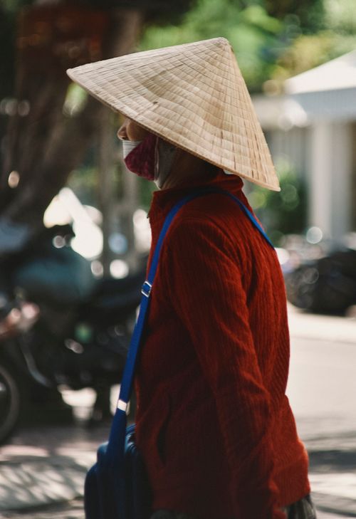 Free A candid portrait of a woman wearing a conical hat on a street in Nha Trang, Vietnam. Stock Photo