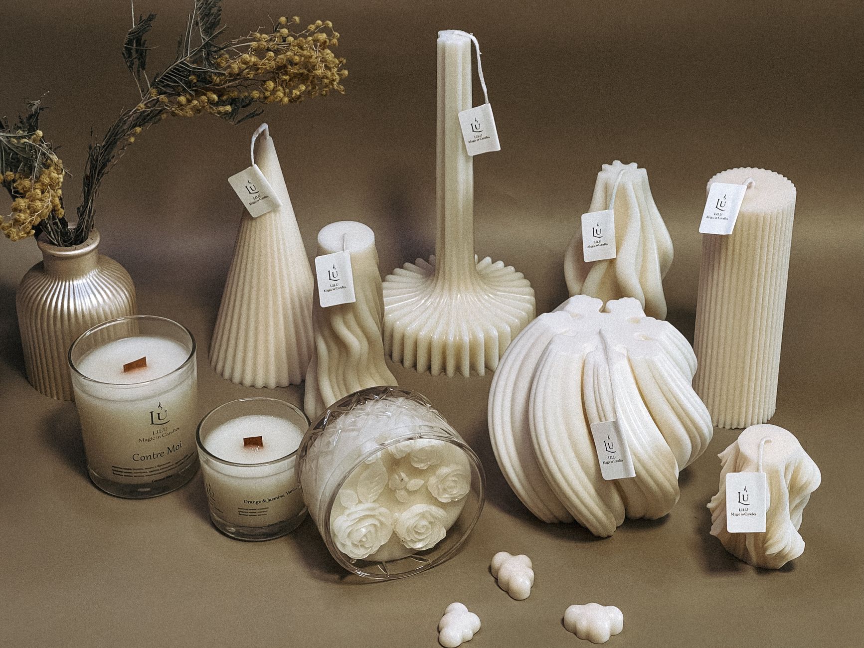 A collection of intricately designed sculpted candles in various shapes, perfect for decor.