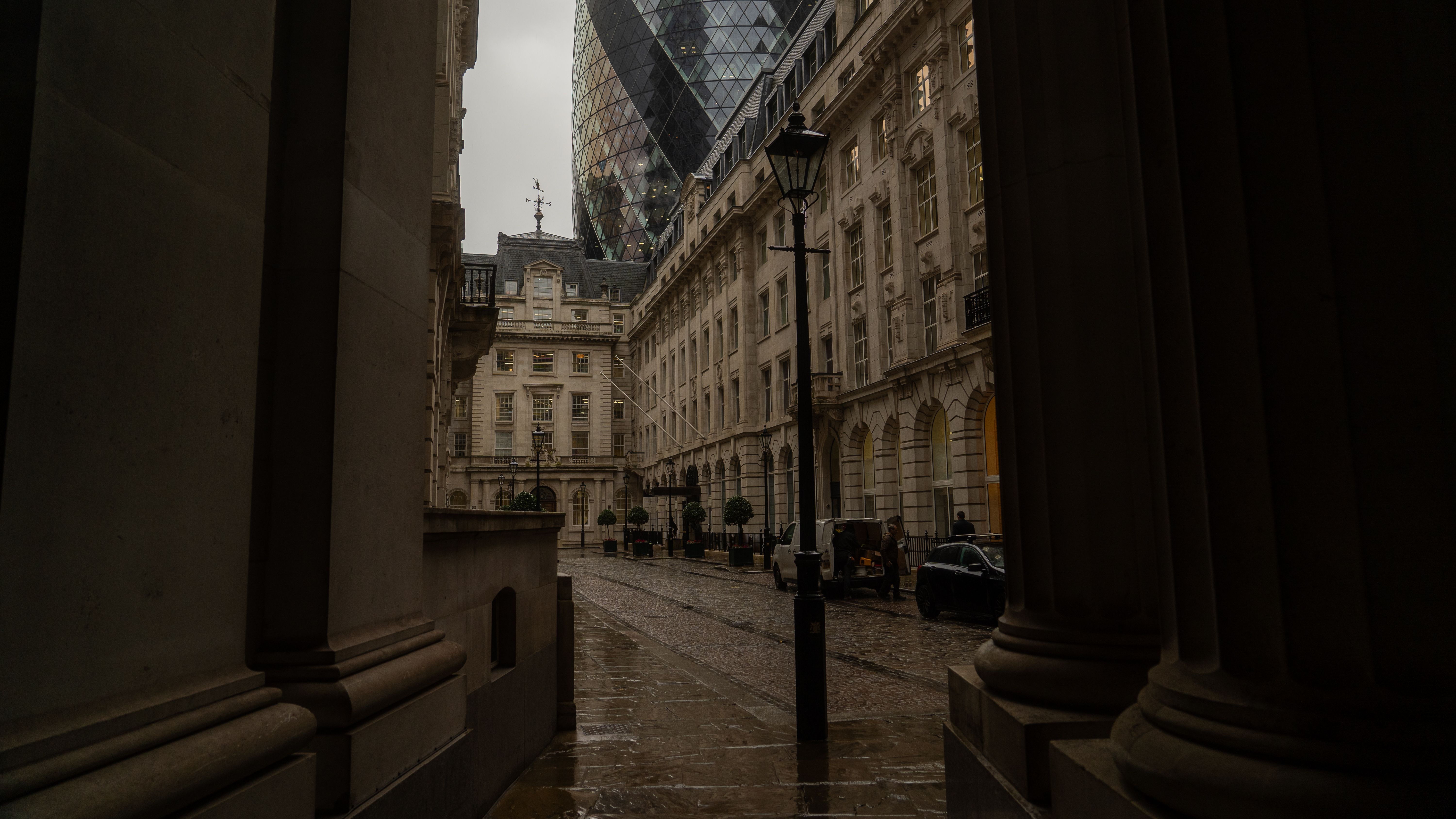Captivating view of London's architecture near the Gherkin on a rainy day. Captivating view of London's architecture near the Gherkin on a rainy day.
