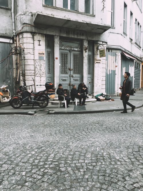Free Street scene in Istanbul featuring people sitting and walking with historical architecture. Stock Photo
