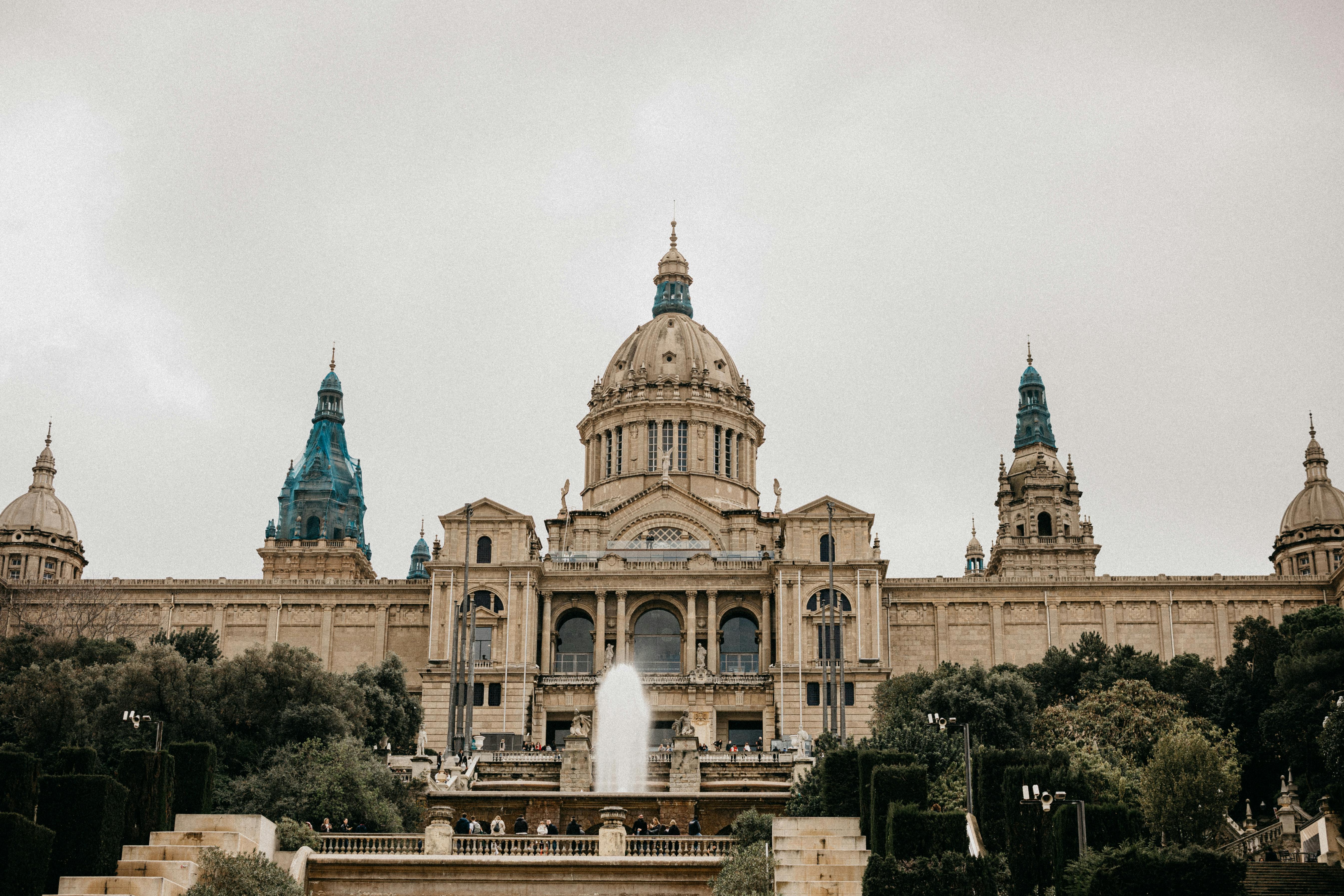 a large building with a fountain in front of it