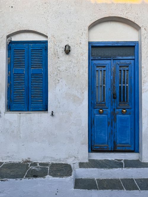 Free Traditional blue door and window on a Greek island with classic architecture. Stock Photo