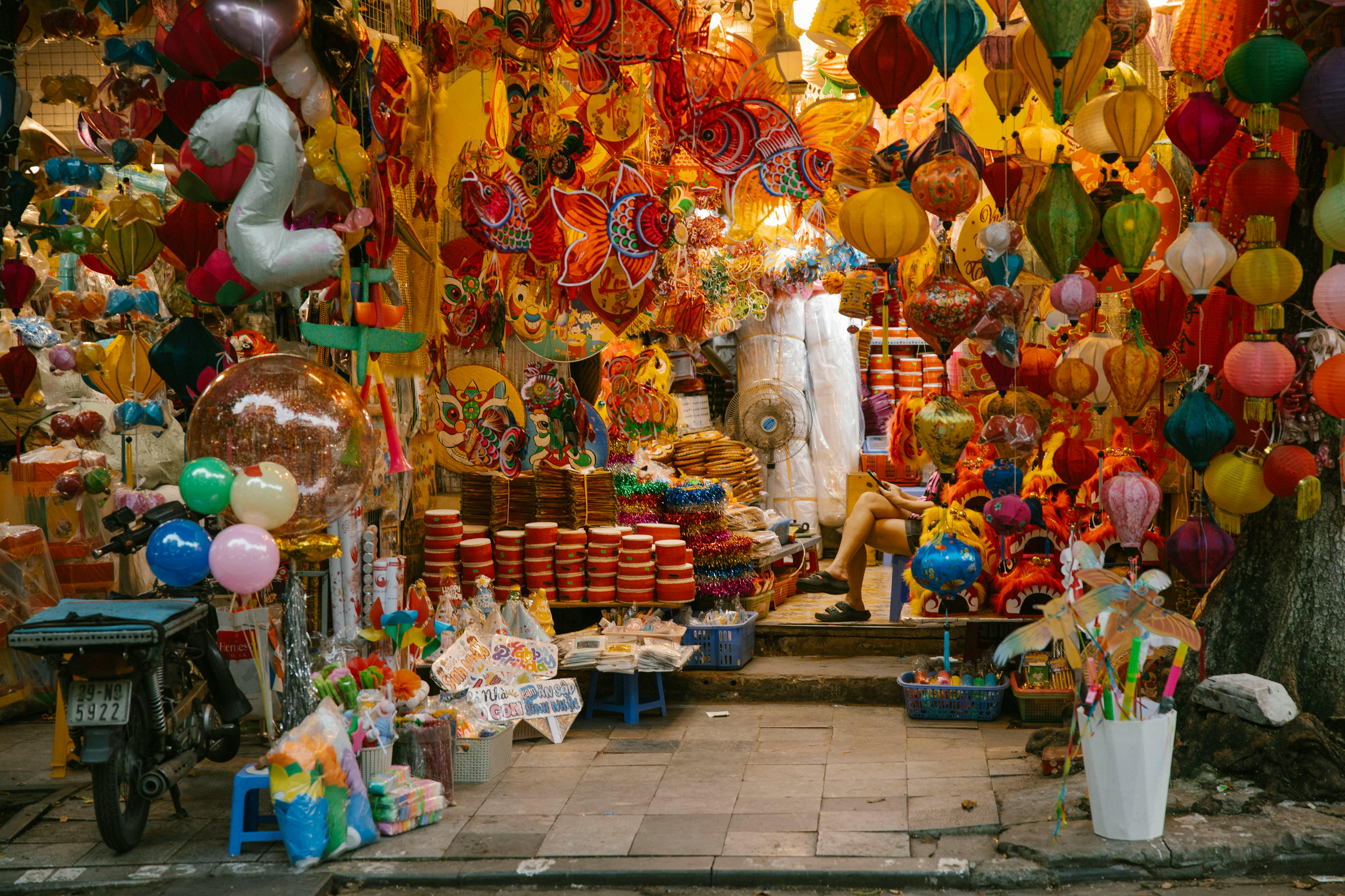 a street with many colorful balloons and lanterns