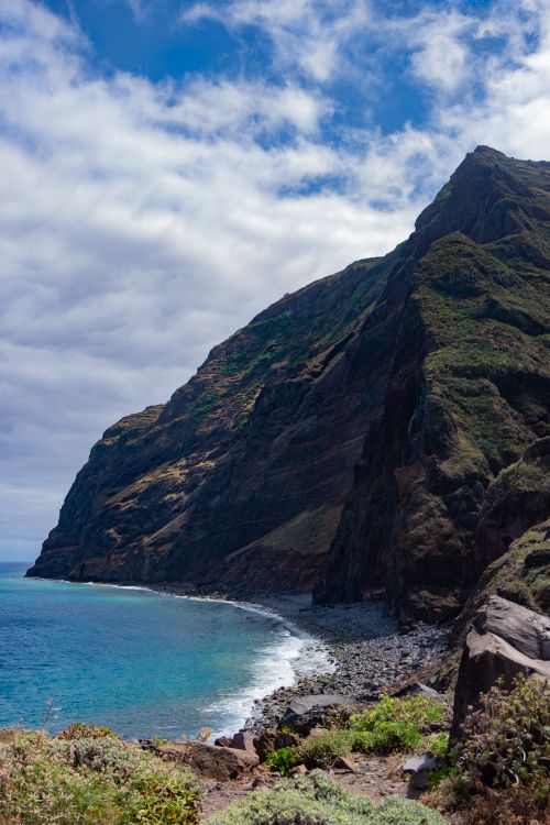 Free Stunning view of Madeira's rugged cliffs and vibrant turquoise waters under a bright sky. Stock Photo
