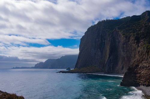Free Majestic coastal cliffs with ocean waves captured on Madeira Island, Portugal. Stock Photo