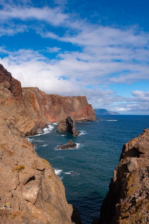 Free Stunning cliffs and azure ocean waves create a dramatic coastal scene in Madeira, Portugal. Stock Photo