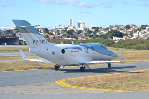 Free Sleek HondaJet on airport runway during clear day, showcasing modern aviation technology. Stock Photo