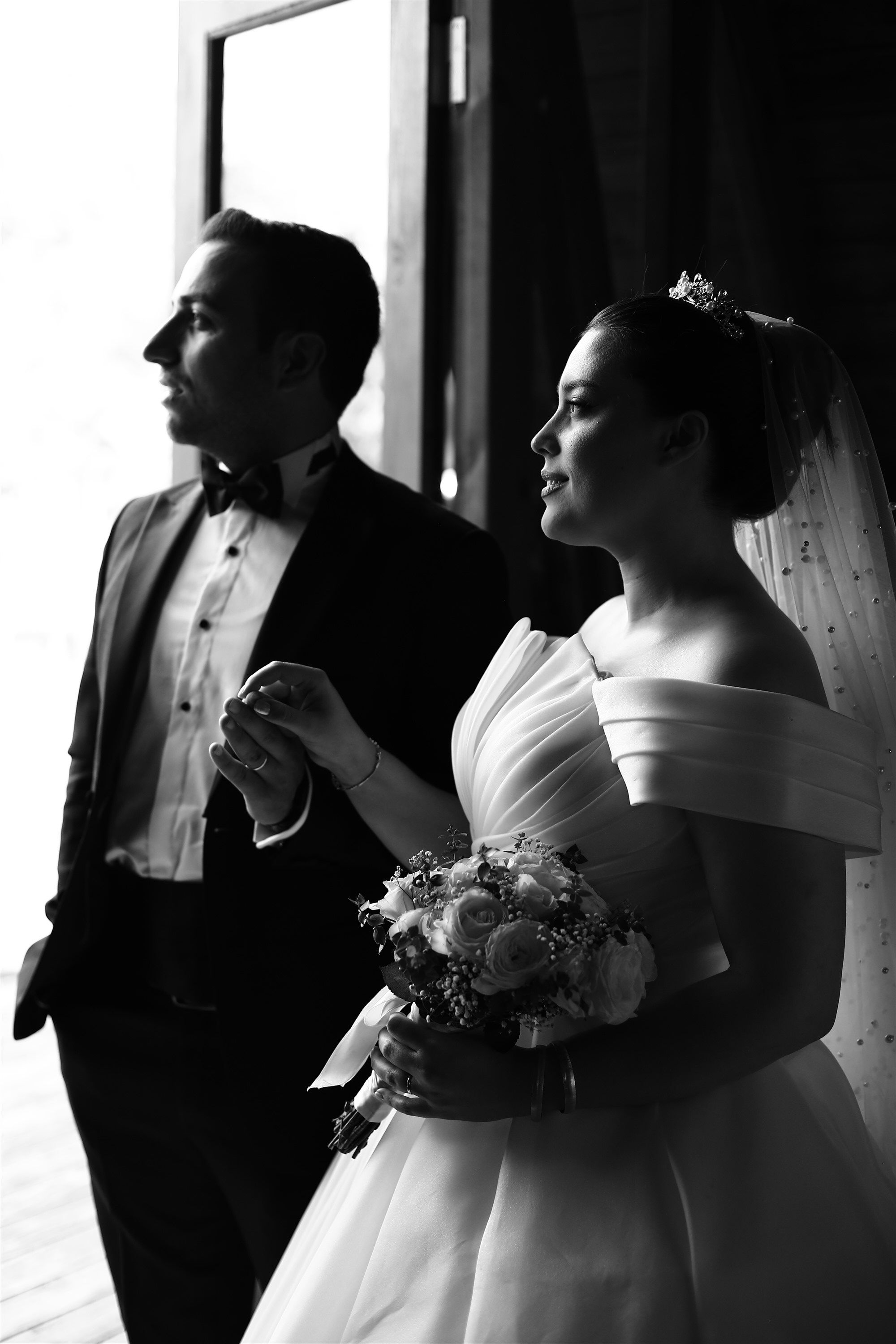 A bride and groom standing in front of a window · Free Stock Photo