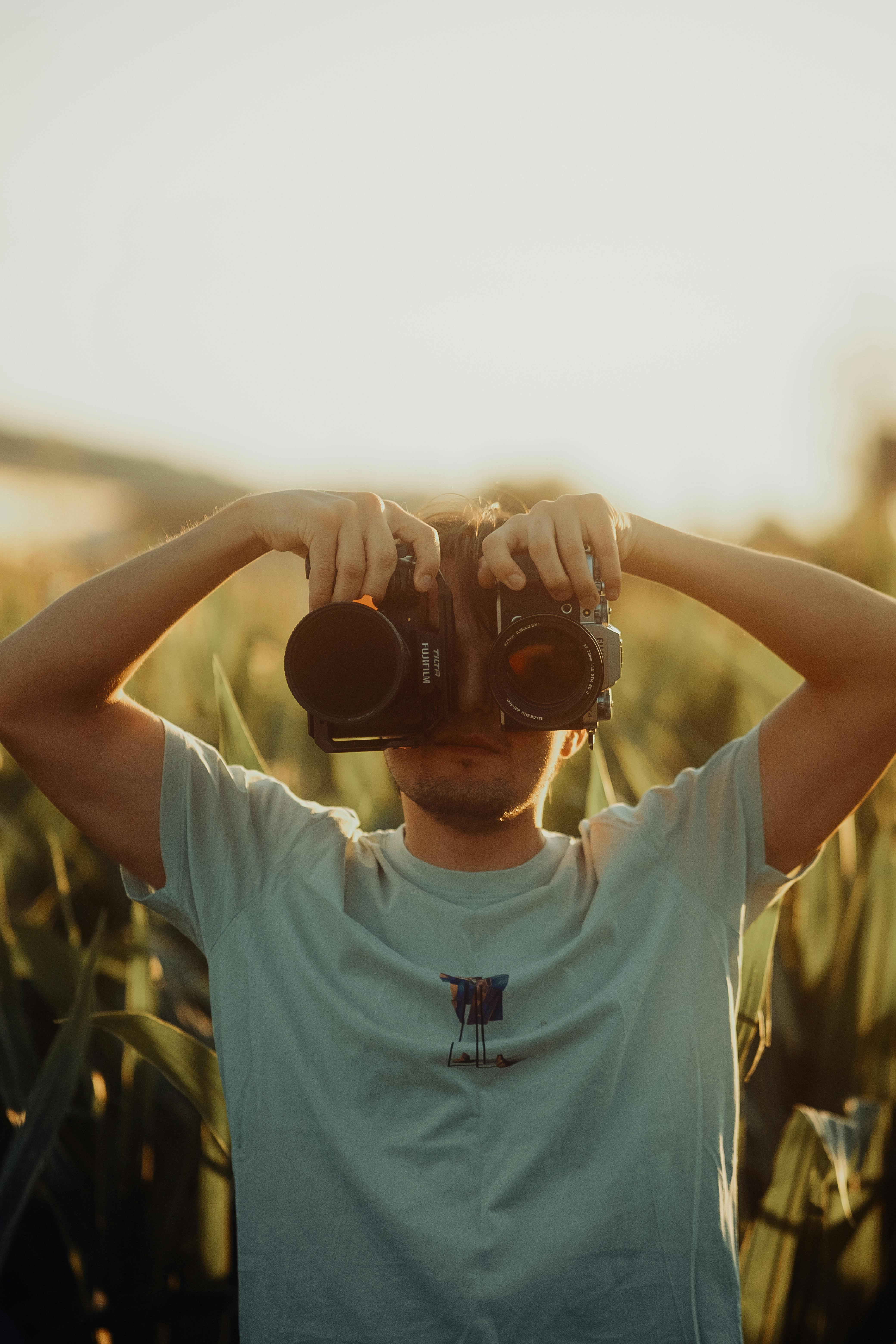 a man holding binoculars in a field