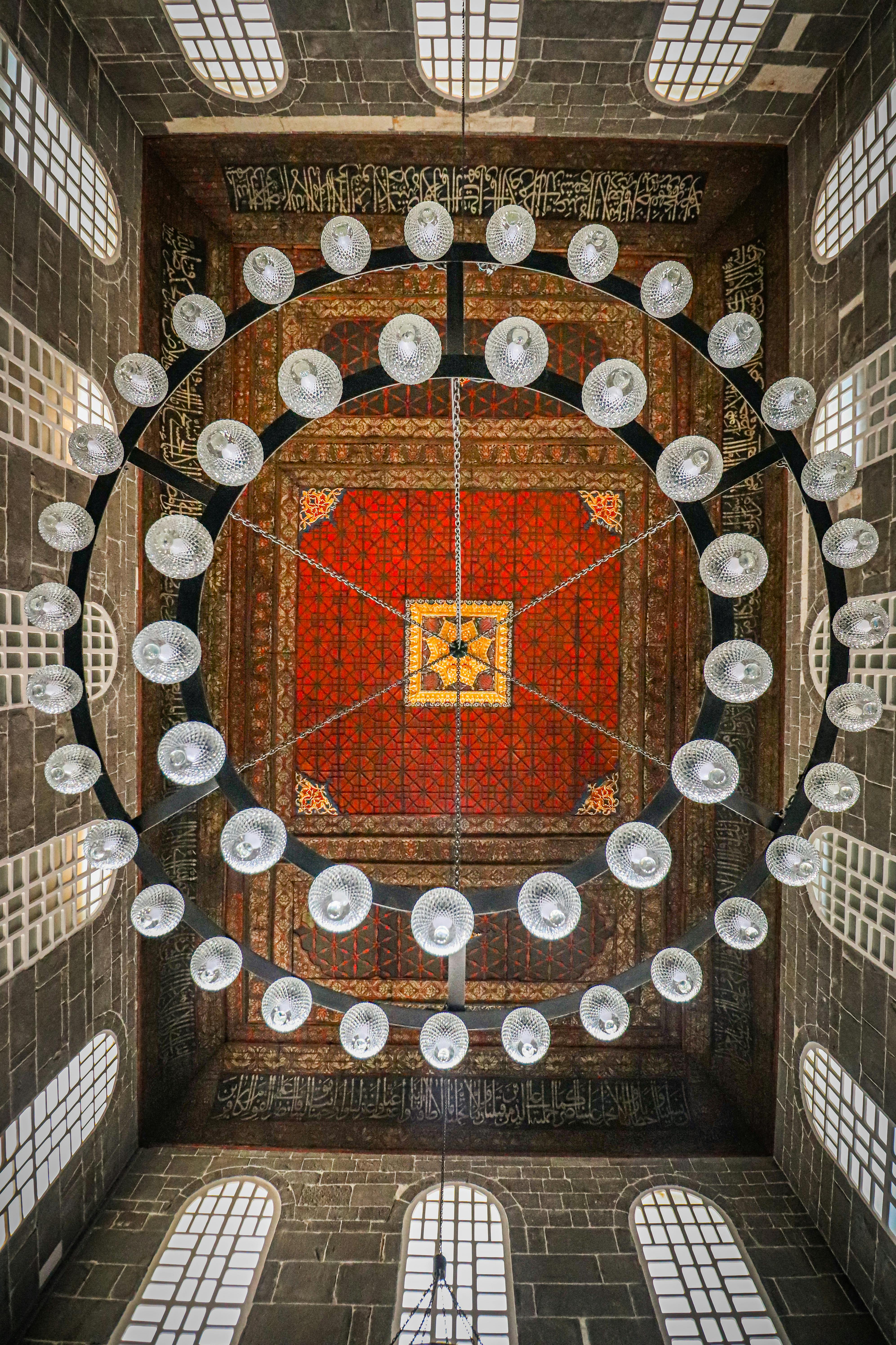 the ceiling of a mosque with a large chandelier