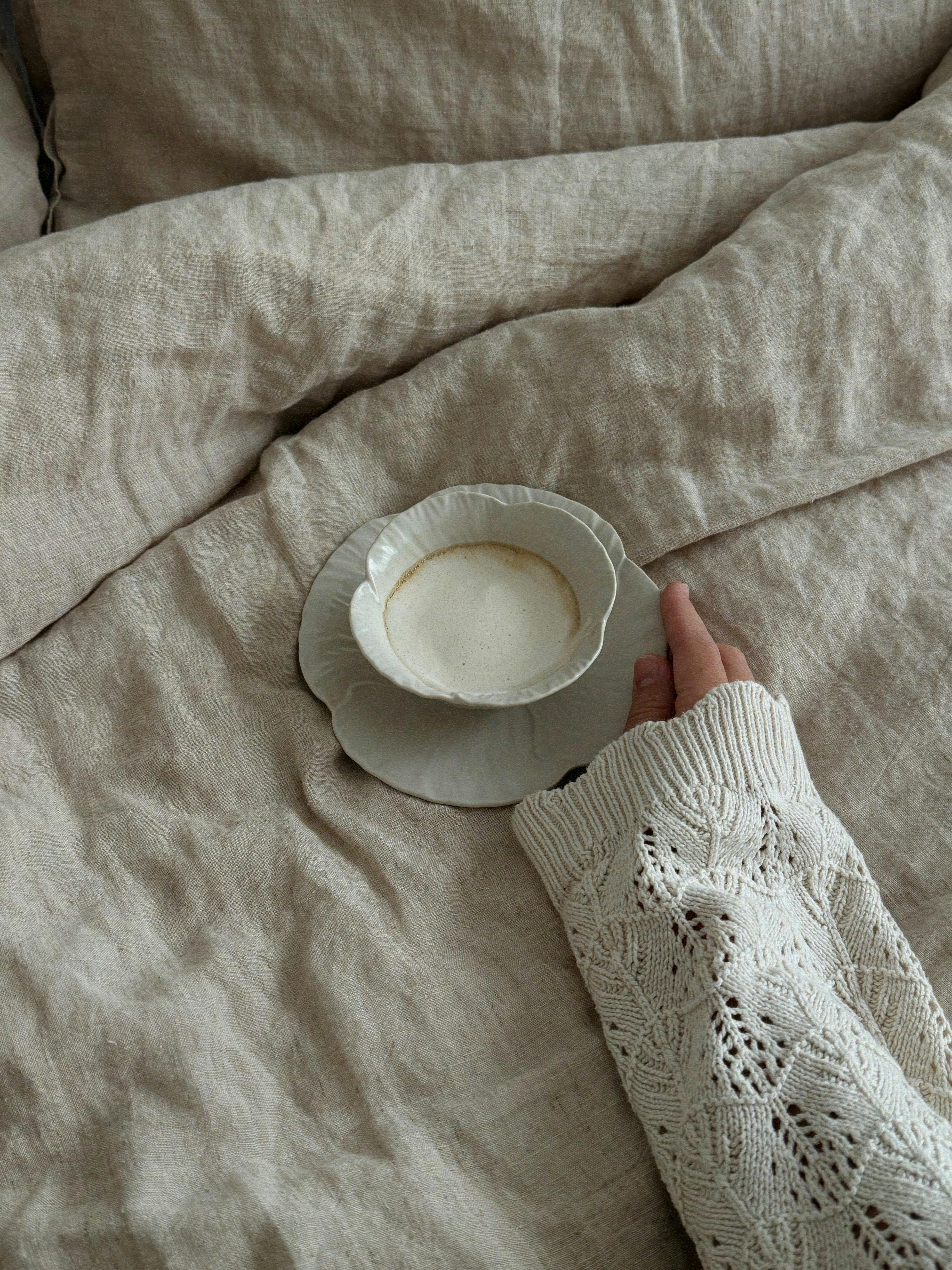 Warm and cozy morning scene with coffee on bed, perfect start to the day.