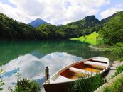 Boat on Dock With Mountain Background