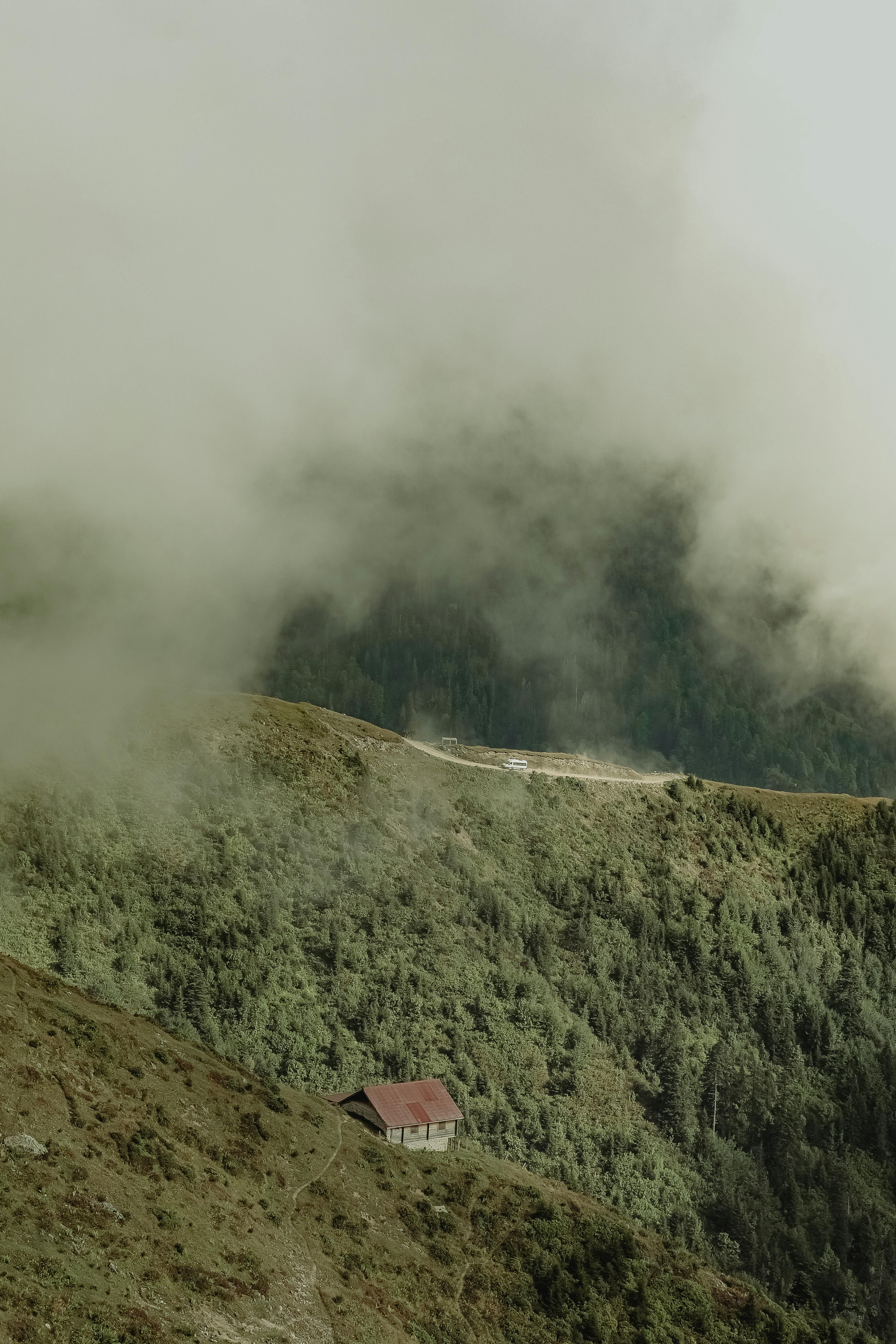 a small cabin sits on top of a mountain