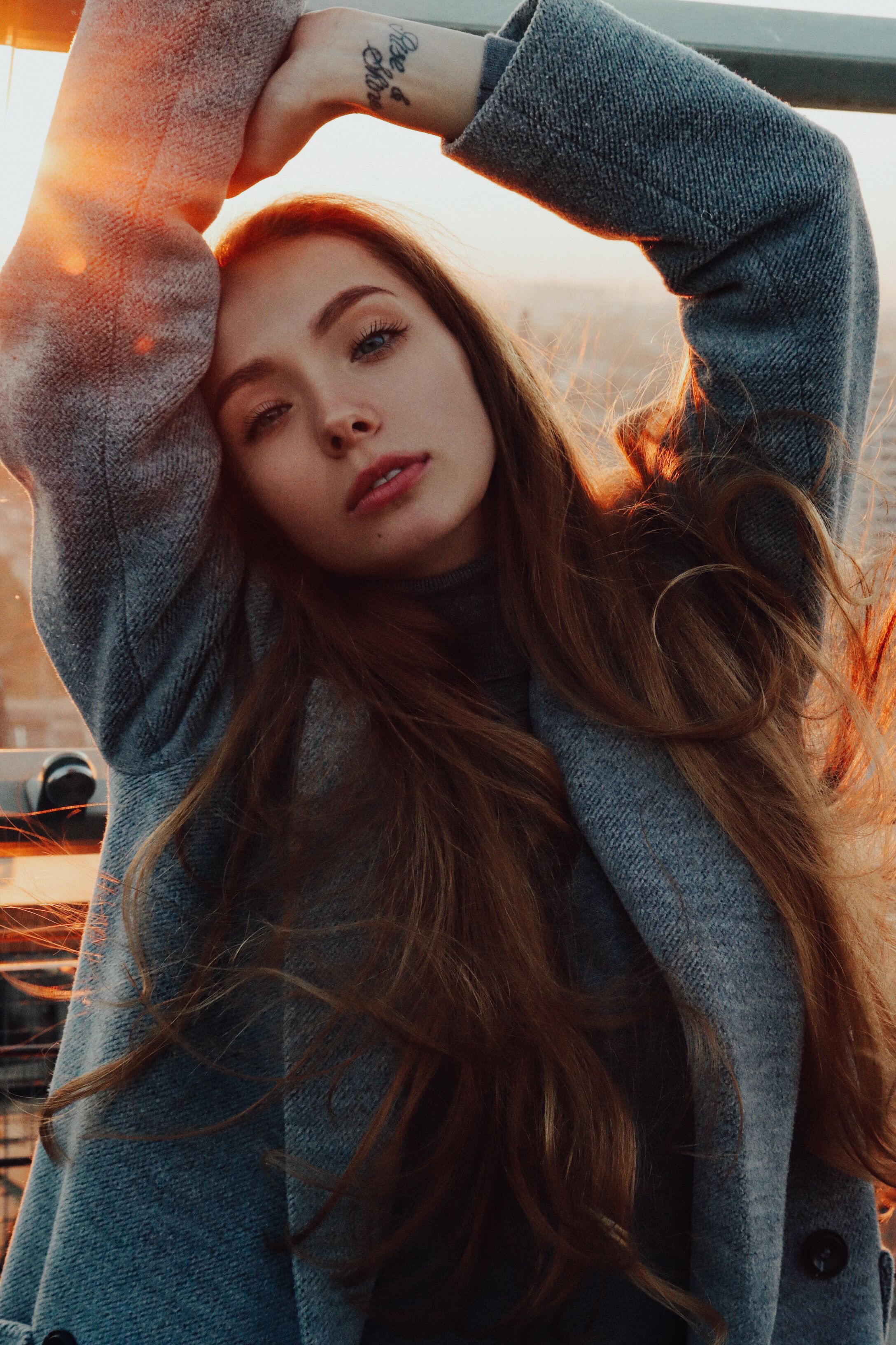 Stunning portrait of a young woman with long hair during sunset, exuding elegance and warmth.