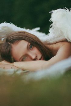 A serene woman reclines on a blanket outdoors, evoking relaxation.
