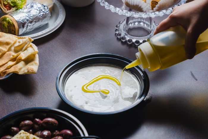 Labneh and toum dip with olive oil and pita