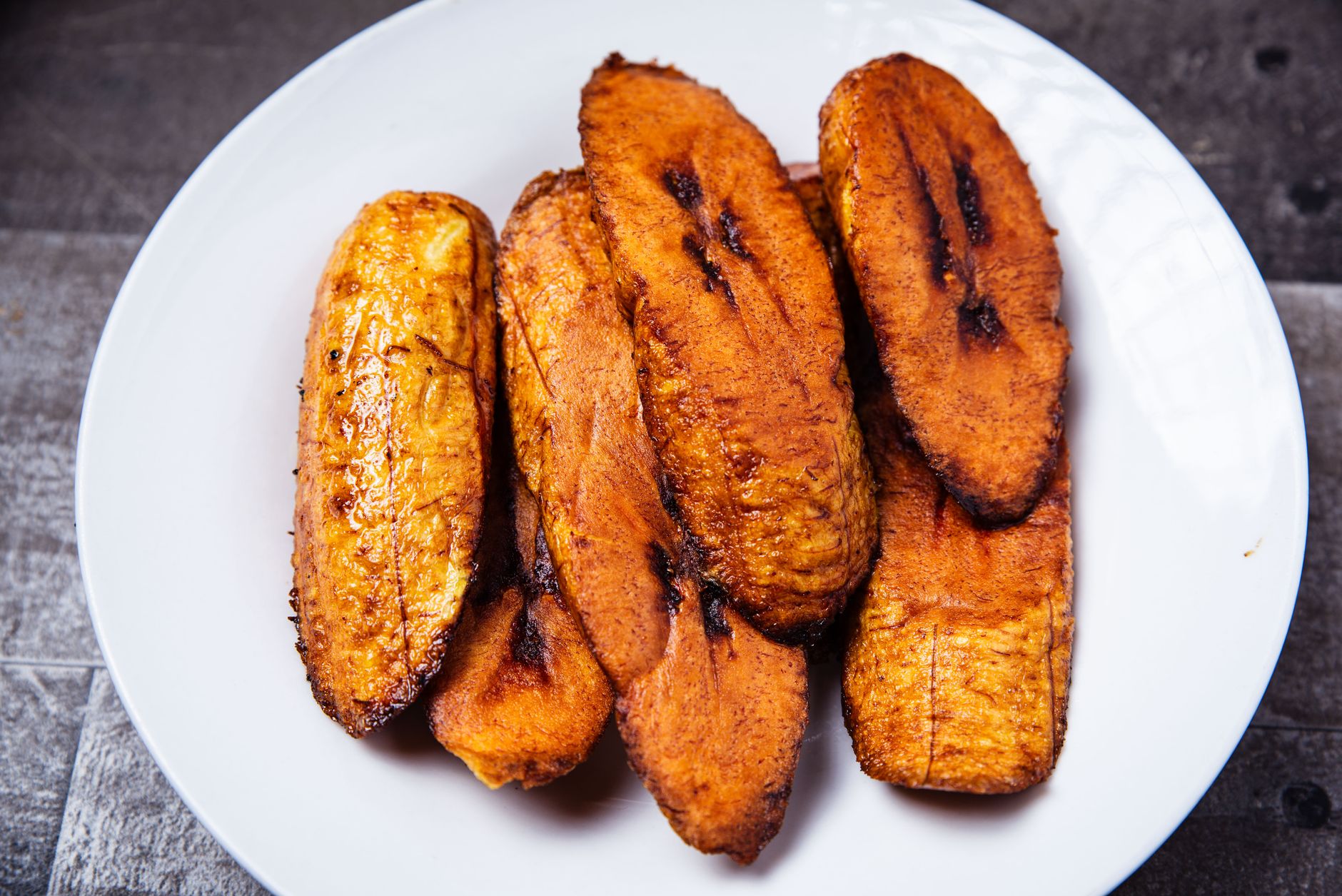 Delicious Caribbean meal featuring fried green plantains and spiced meat