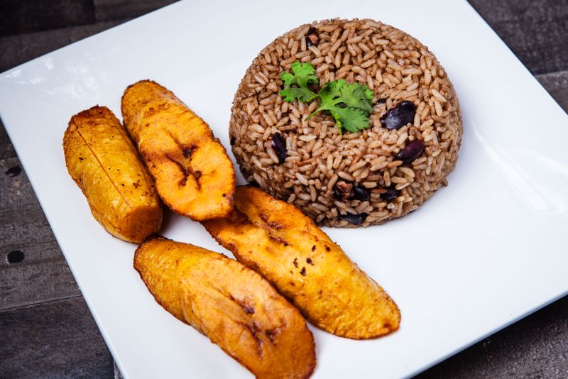 A plate of rice, beans and fried plantains.