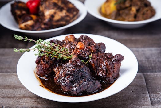 Delicious braised oxtail served with herbs in a rich sauce, perfect for a gourmet meal.