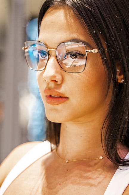 Portrait of a fashionable young woman wearing elegant eyeglasses indoors.