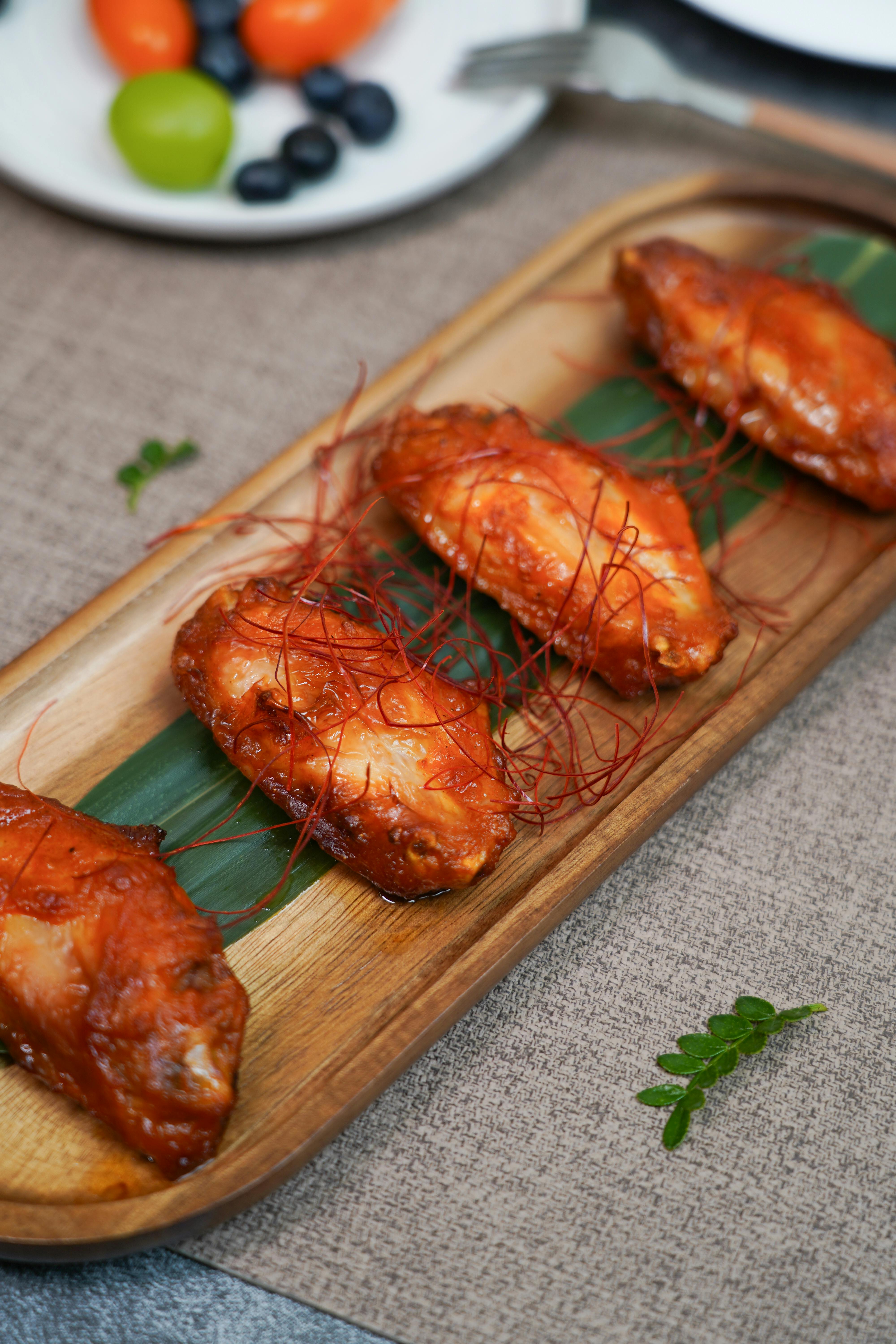 Gourmet Spanish chicken wings with dipping sauce and herbs
