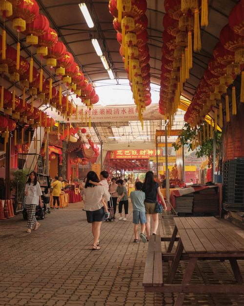 Free Bustling street market adorned with red lanterns, vibrant atmosphere and people shopping. Stock Photo
