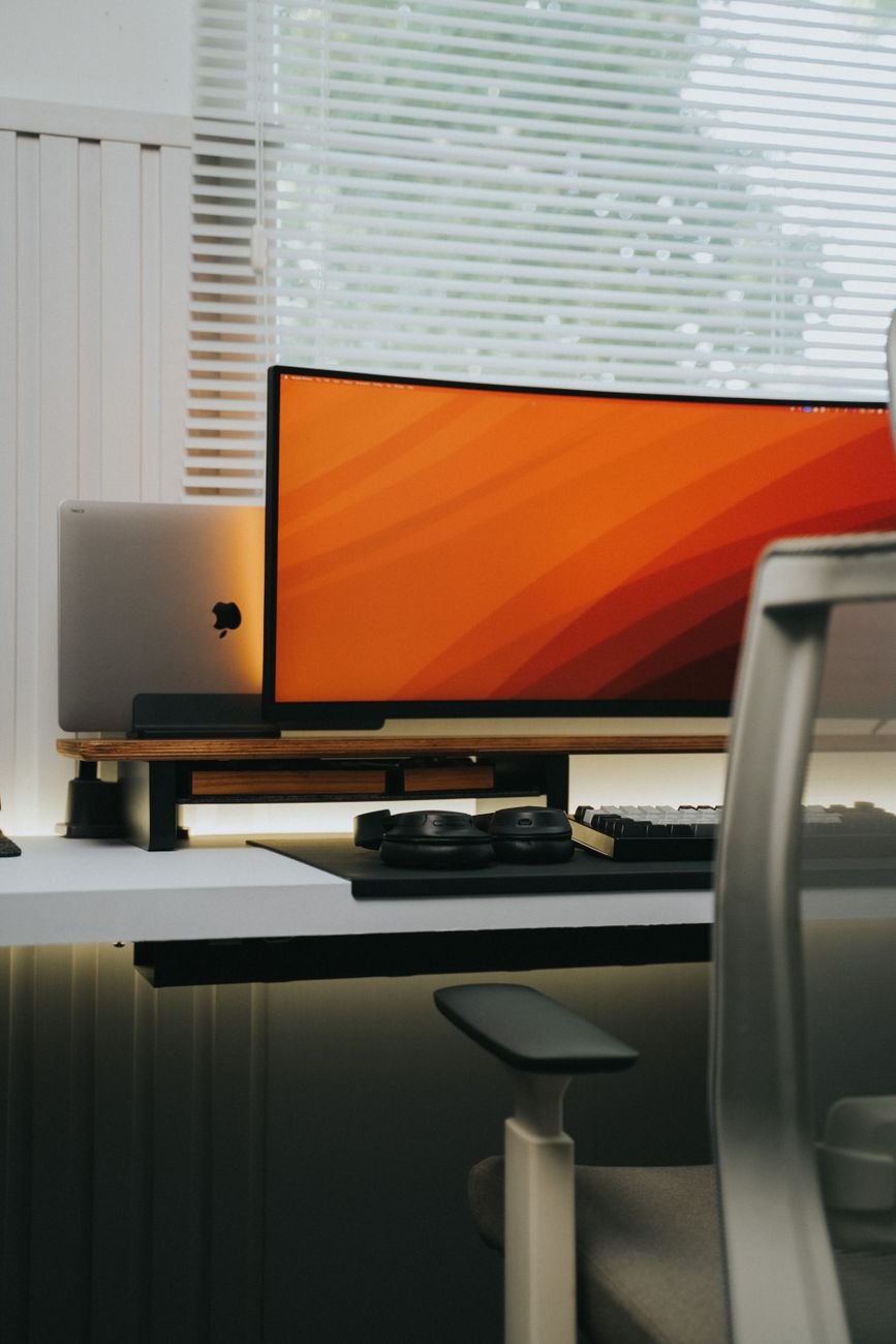 Sleek contemporary workspace featuring a minimalist design with a tech-centric setup.