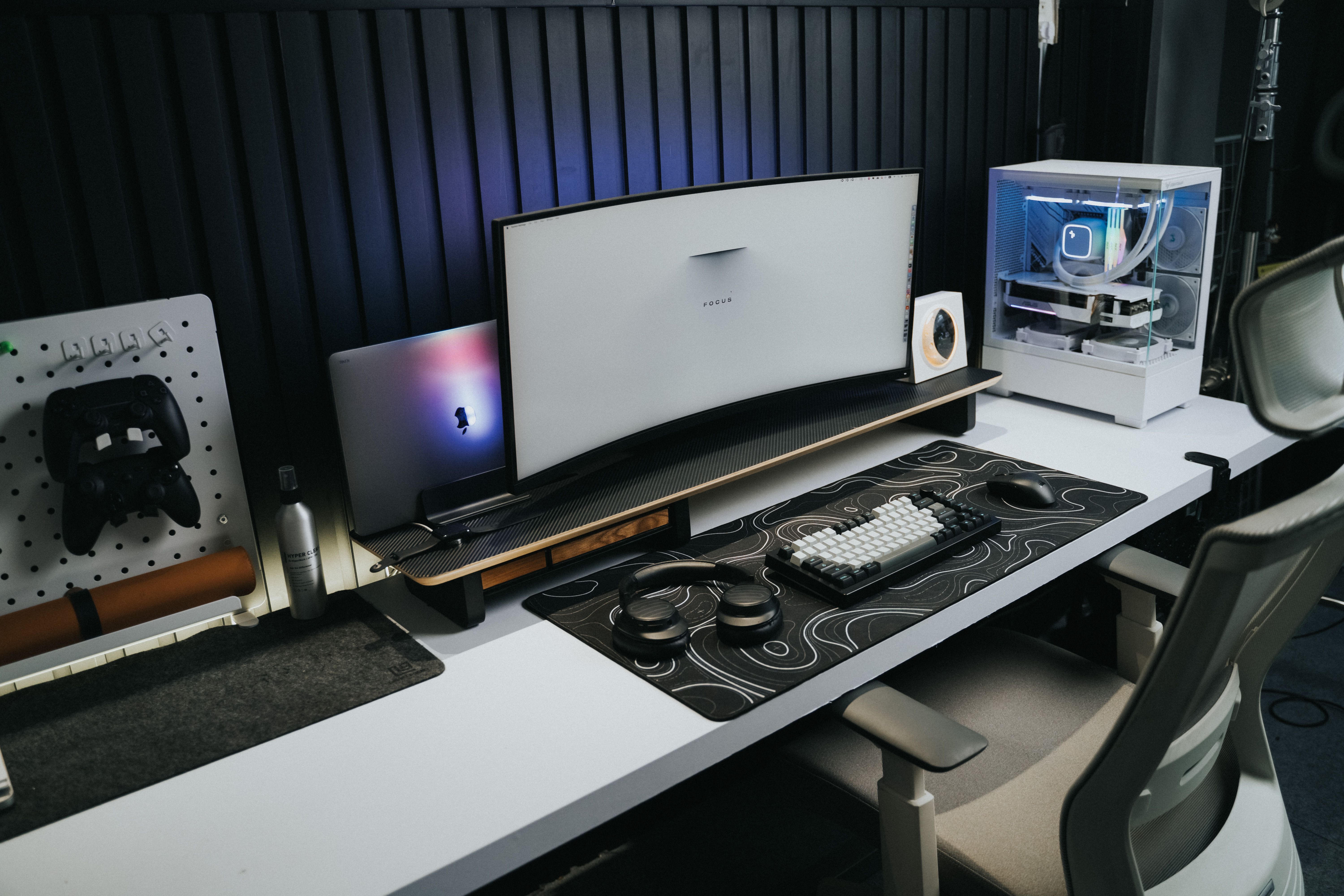 A cluttered, inspiring home workspace at night, next to a sleek, organized office setup during the day