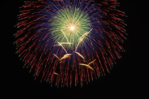 Free Vibrant multicolored fireworks burst illuminating the night sky. Perfect for festive, celebration themes. Stock Photo
