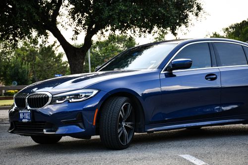 Free Blue sedan parked outdoors on a summer day in Arlington, Texas, showcasing luxury design and style. Stock Photo
