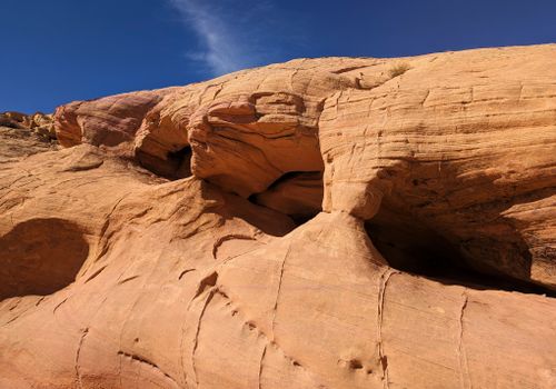 Free Explore the rugged beauty of sandstone formations with intricate erosion patterns under a clear blue sky. Stock Photo
