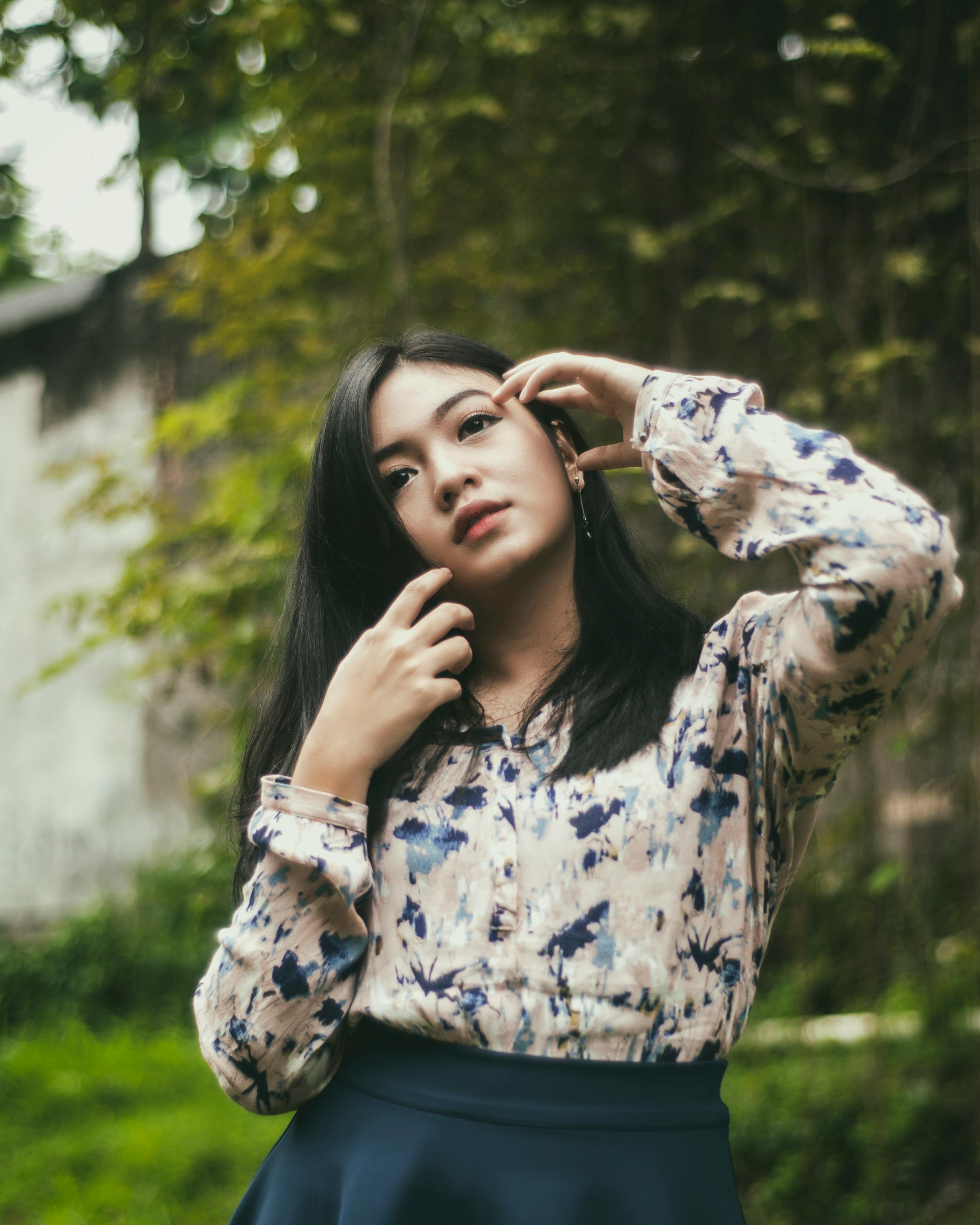 Images Pose Blouse young woman Legs Asian Made of bricks walls